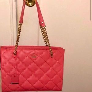 Dark pink quilted Kate Spade bag.